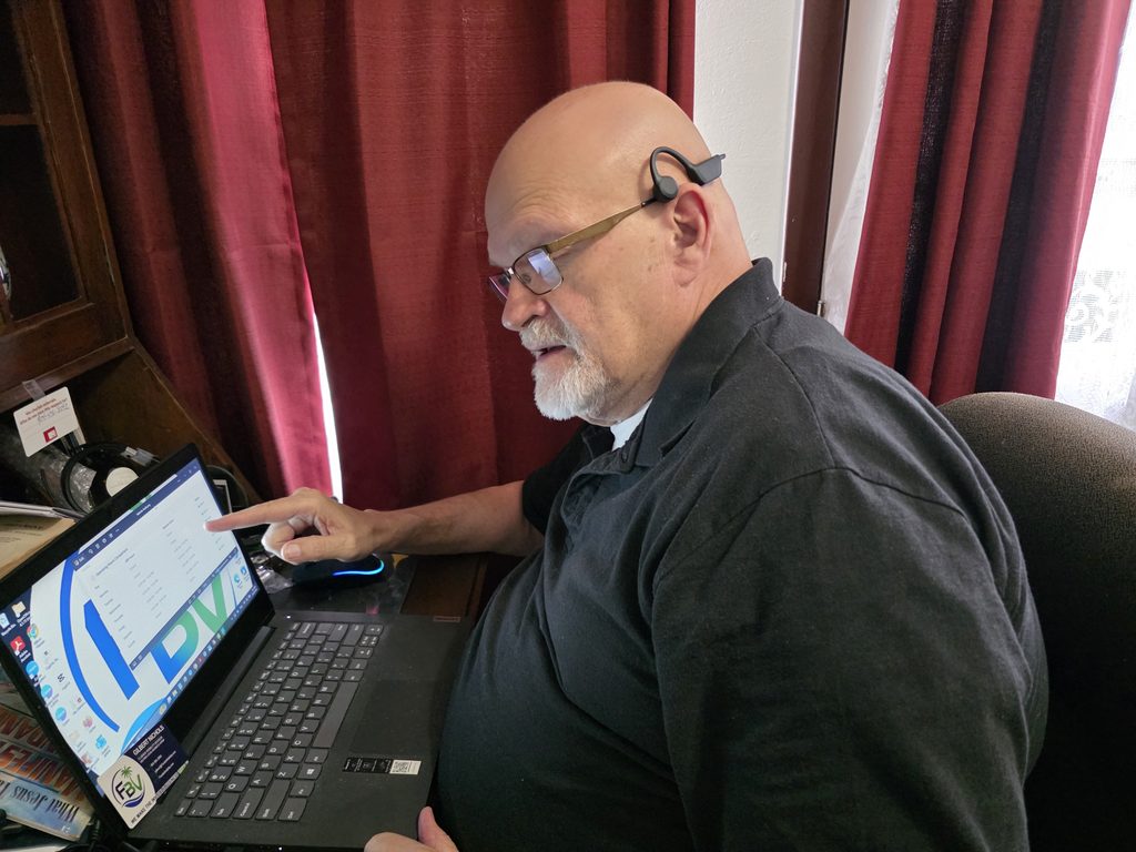 “Gilbert Nichols at his desk reviewing a local business’s online visibility.